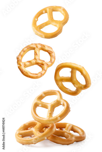 Obraz na płótnie A pretzel falling on a white background, a pretzel levitating. Isolated