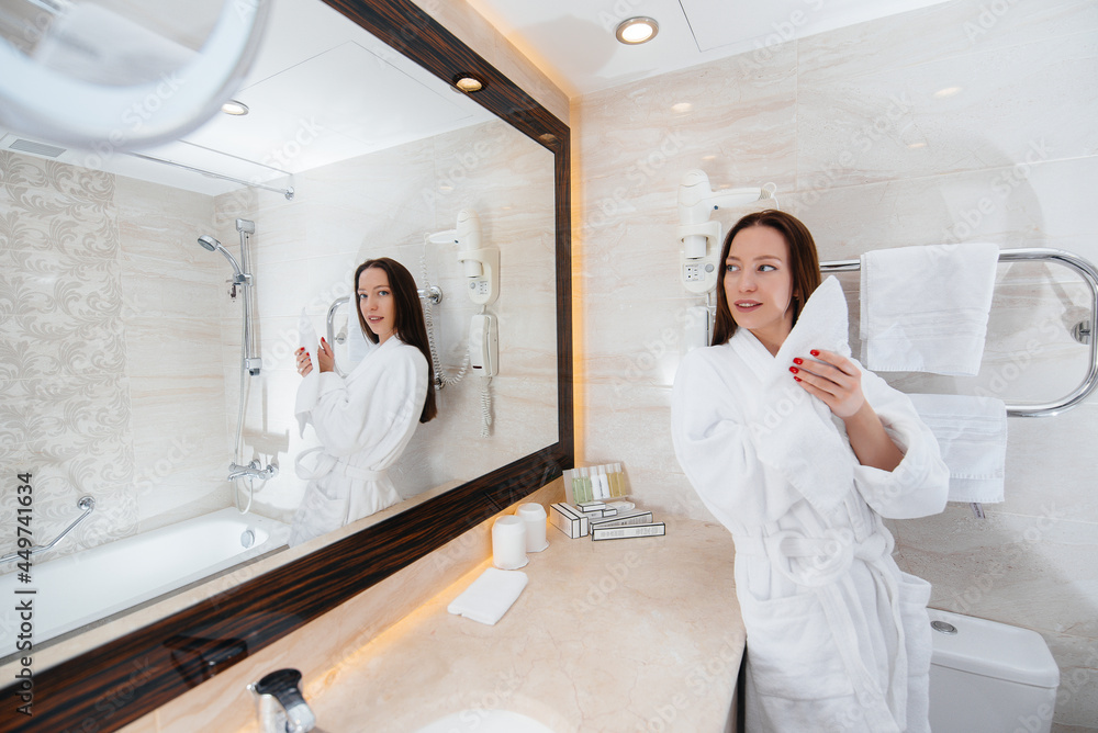 Young beautiful girl in a white beautiful bathroom. Fresh good morning at the hotel. Young beautiful girl in a white beautiful bathroom. Fresh good morning at the hotel.