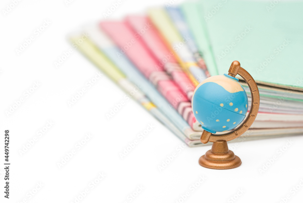 small globe on the background of school notebooks small globe on the background of school notebooks