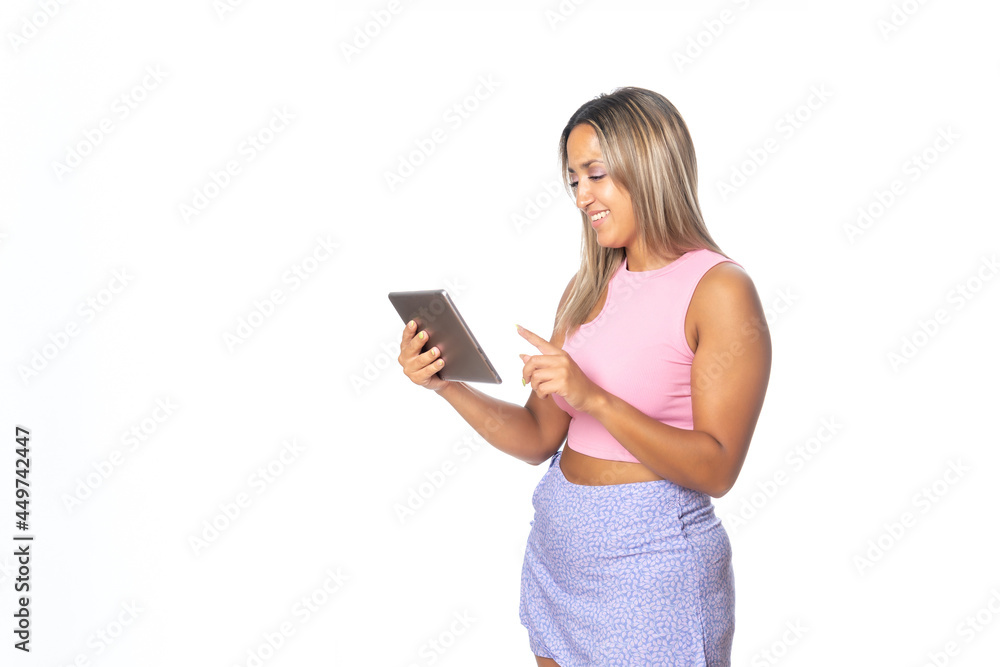 Super happy girl holding a tablet isolated on white background