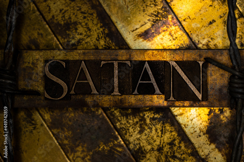 Satan text message on textured grungy bronze background