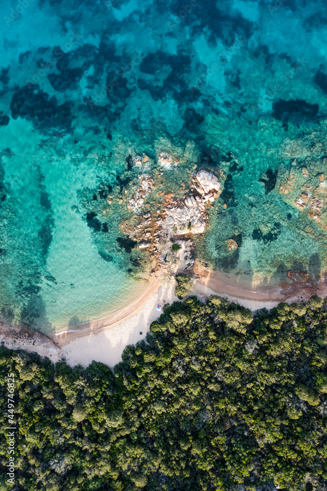 View from above, stunning aerial view of a green coastline with some empty beaches bathed by a beautiful and turquoise sea. Liscia Ruja,Sardinia, Italy.