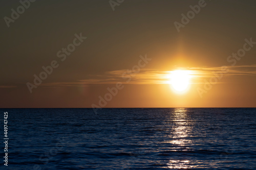 Sunset in the ocean. Beautiful seascape. Relaxation and summer beach vacation concept