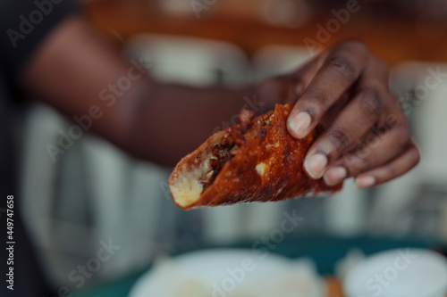 Close up of a hand holding a taco
