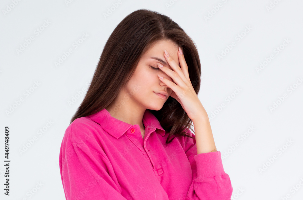 facepalm embarrassment and shame emotion. ashamed girl covering her face with a hand. young beautiful woman portrait on white background. facepalm embarrassment and shame emotion. ashamed girl covering her face with a hand. young beautiful woman portrait on white background.