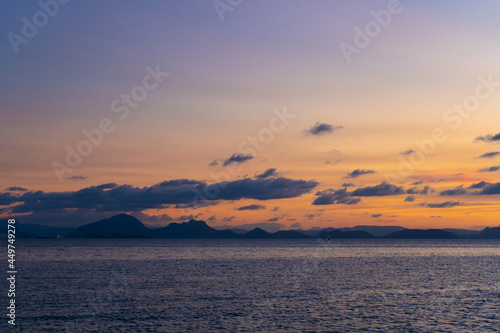Wonderful sunset landscape on the seashore, colors of the sunset sky and silhouette of island in the water. incredible tropical sunset © Kate