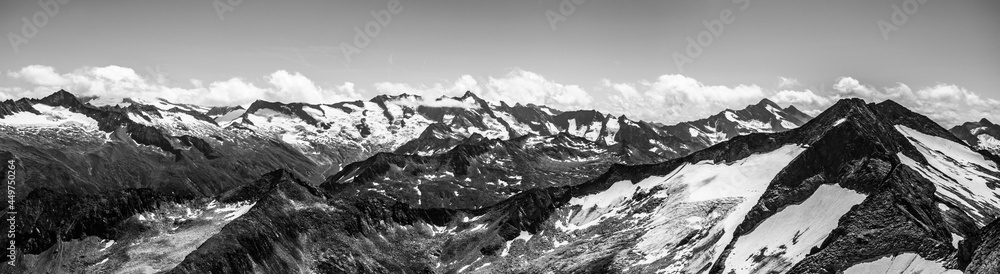 Alpnine rocky peaks panorama on sunny summer day. Austrian Alps, Austria. Black and white image.