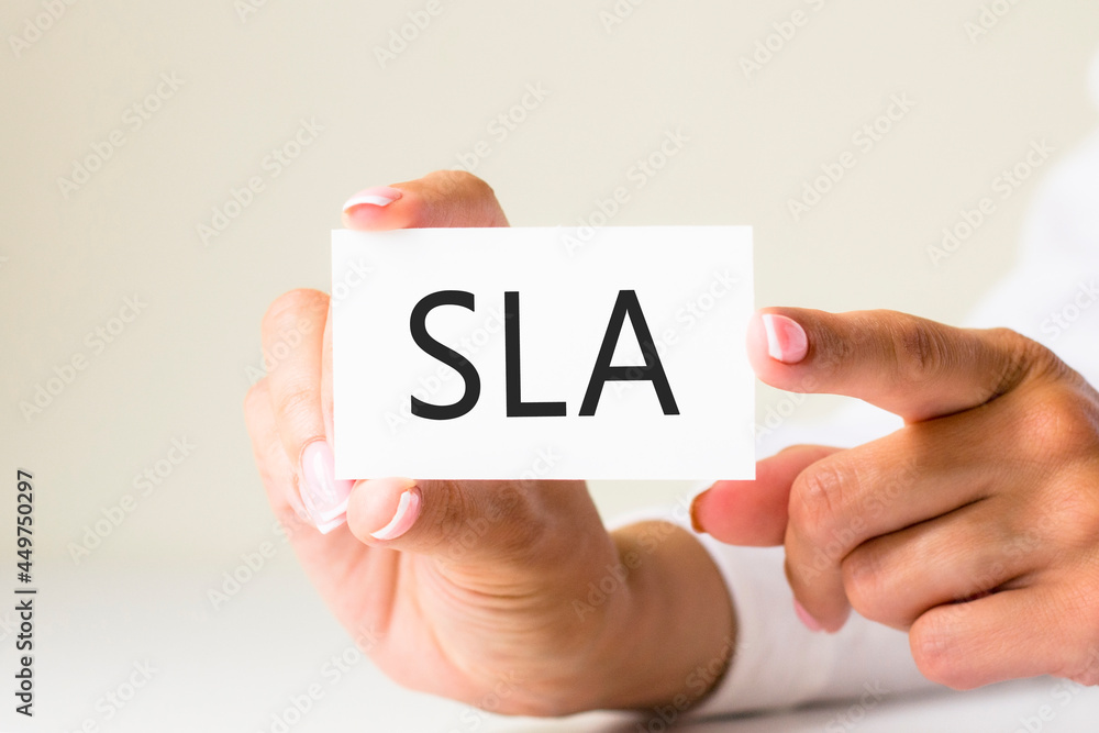phrase SLA - Service Level Agreement - written on a white paper card phrase SLA - Service Level Agreement - written on a white paper card