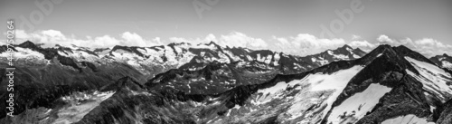 Alpnine rocky peaks panorama on sunny summer day. Austrian Alps, Austria. Black and white image.