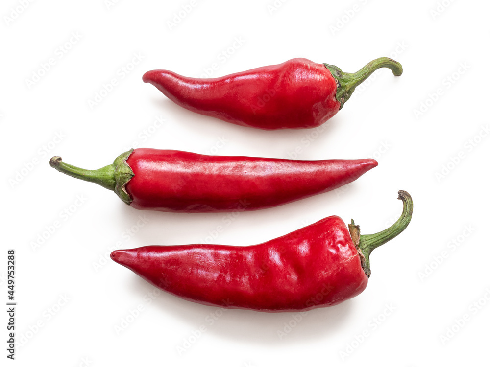 Three pods of red hot chili pepper on a white background Three pods of red hot chili pepper on a white background