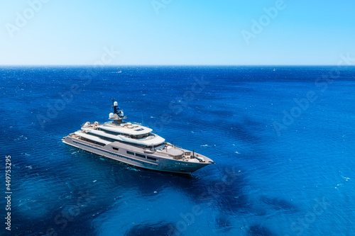 Aerial view of the ship from drone. Blue clear water in the Mediterranean Sea. Summer vacation and travel on a cruise liner. Summer trip. © biletskiyevgeniy.com