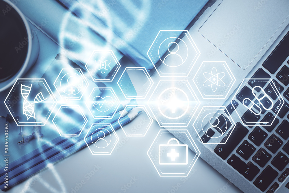 DNA hologram drawings over computer on the desktop background. Top view. Multi exposure. Concept medical education. DNA hologram drawings over computer on the desktop background. Top view. Multi exposure. Concept medical education.