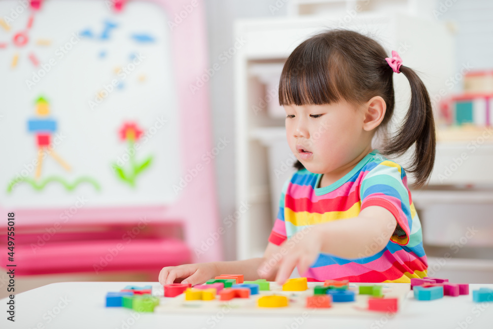 young girl learning letter blocks for homeschooling young girl learning letter blocks for homeschooling