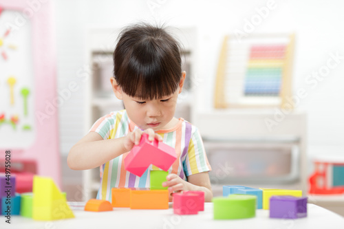young girl playing creative blocks at home