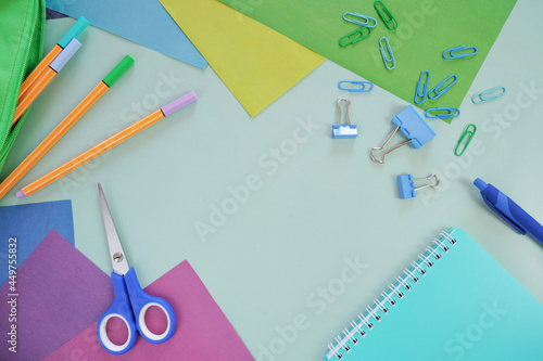 Close-up of office supplies on a blue background. Background of school supplies on a blue background, place for text. Back to school. 