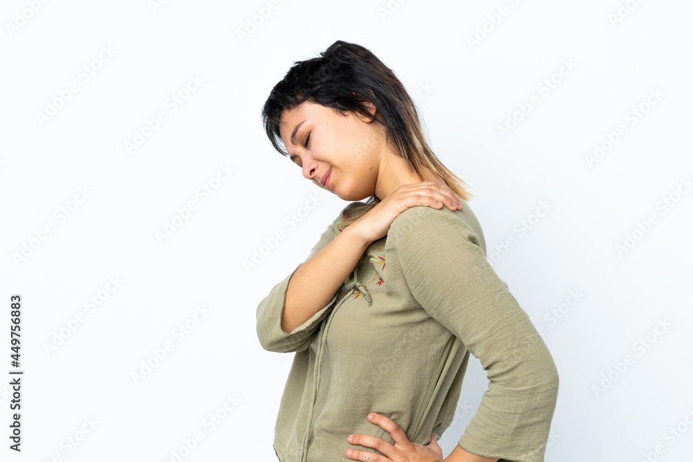 Young Uruguayan girl over isolated white background suffering from pain in shoulder for having made an effort Young Uruguayan girl over isolated white background suffering from pain in shoulder for having made an effort