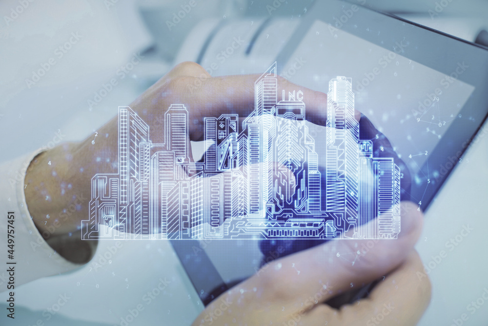 Double exposure of man's hands holding and using a digital device and city drawing. Double exposure of man's hands holding and using a digital device and city drawing.