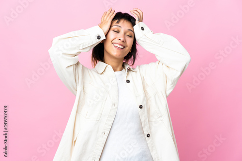Young Uruguayan woman over isolated pink background laughing