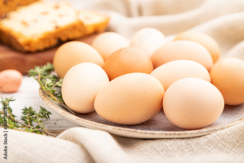 Homemade easter pie with raisins and eggs on plate on a white wooden background. side view, close up, selective focus. Homemade easter pie with raisins and eggs on plate on a white wooden background. side view, close up, selective focus.