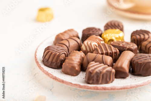 Chocolate candies with cup of coffee. side view, selective focus.