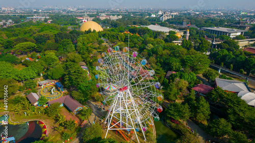 Aerial view of Ferris wheel which is located on the Taman legenda at a Taman Mini Indonesia Indah with noise cloud. Jakarta, Indonesia