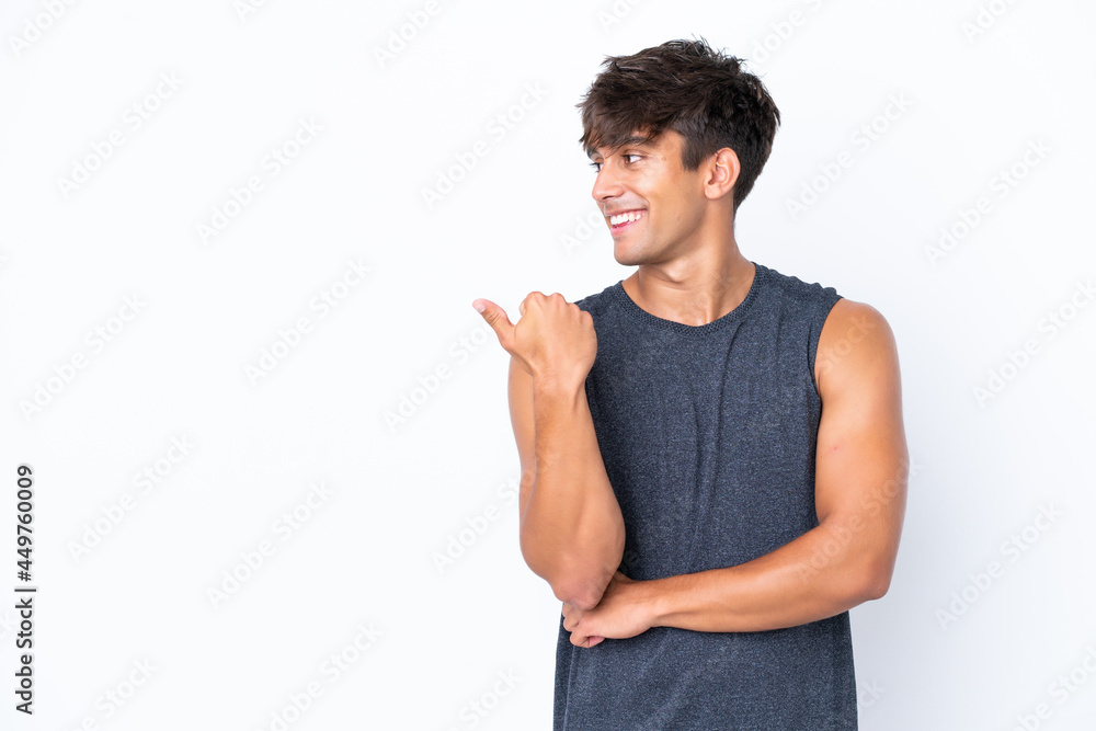 Young sport caucasian man isolated on white background pointing to the side to present a product Young sport caucasian man isolated on white background pointing to the side to present a product