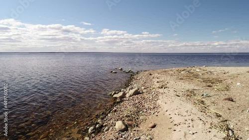 Dron flight over ground towards sea horizon 