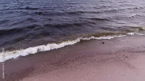 Aerial panoramic shot of waves reaching the beach in the evening