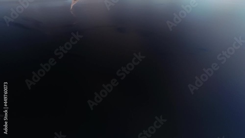 Vertical aerial shot of big island in the sea in the evening