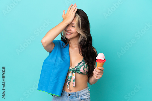 Teenager caucasian girl holding ice cream and towel isolated on blue background has realized something and intending the solution