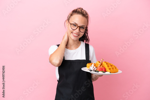 Restaurant waiter Russian girl holding waffles isolated on pink background laughing