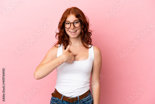 Teenager reddish woman isolated on pink background with surprise facial expression