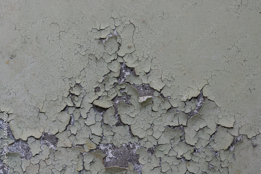 Peeling paint on the wall. Old concrete wall with cracked flaking paint. Weathered rough painted surface with patterns of cracks and peeling. Grunge texture for background and design. High resolution. Peeling paint on the wall. Old concrete wall with cracked flaking paint. Weathered rough painted surface with patterns of cracks and peeling. Grunge texture for background and design. High resolution.