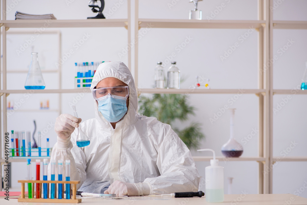 Young male chemist working at the lab during pandemic Young male chemist working at the lab during pandemic