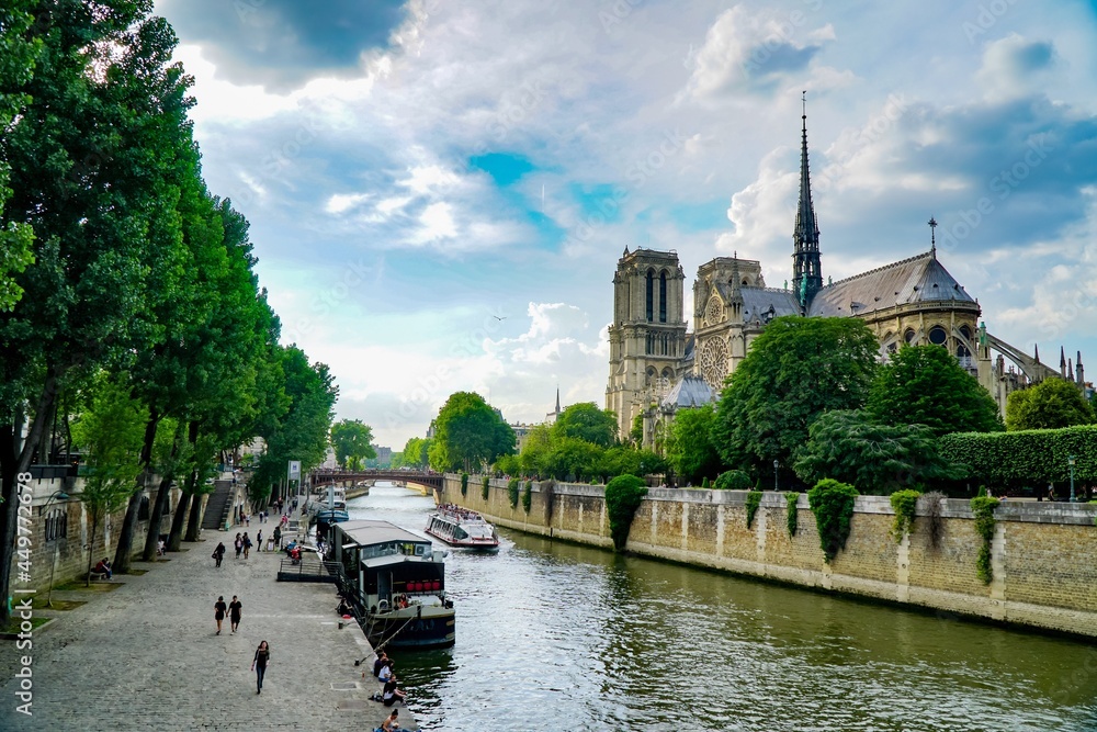 Notre Dame cathedral with boat on Seine river in Paris, France.