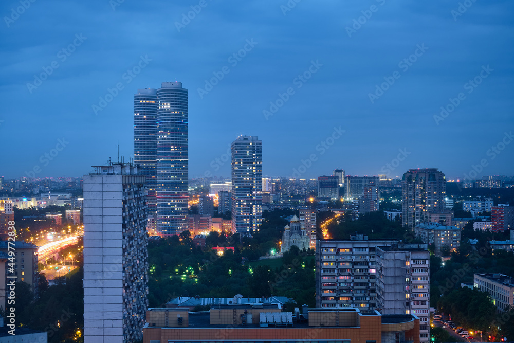 Naklejka premium Moscow, Russia - May 26, 2021: Night view from the Cosmos Hotel on the buildings of the city of Moscow. The surroundings around VDNKh and Ostankino TV Tower.