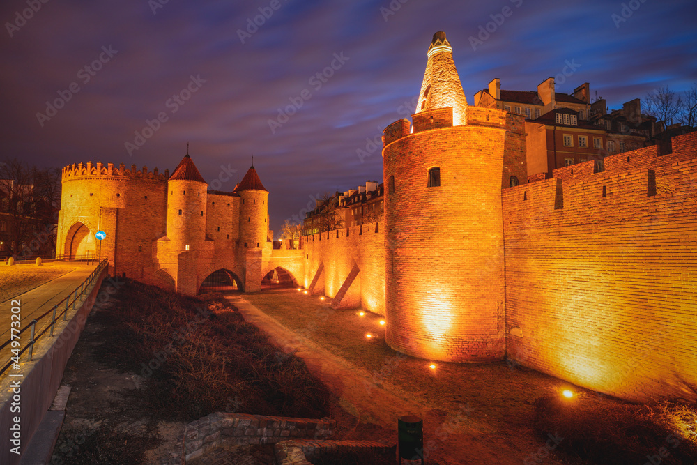 Poland, Masovia, Warsaw, Old City walls and barbican illuminated at night Poland, Masovia, Warsaw, Old City walls and barbican illuminated at night