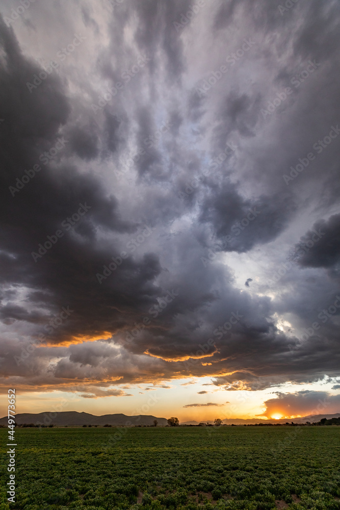 Usa, Idaho, Bellevue, Storm clouds over fields at sunset Usa, Idaho, Bellevue, Storm clouds over fields at sunset