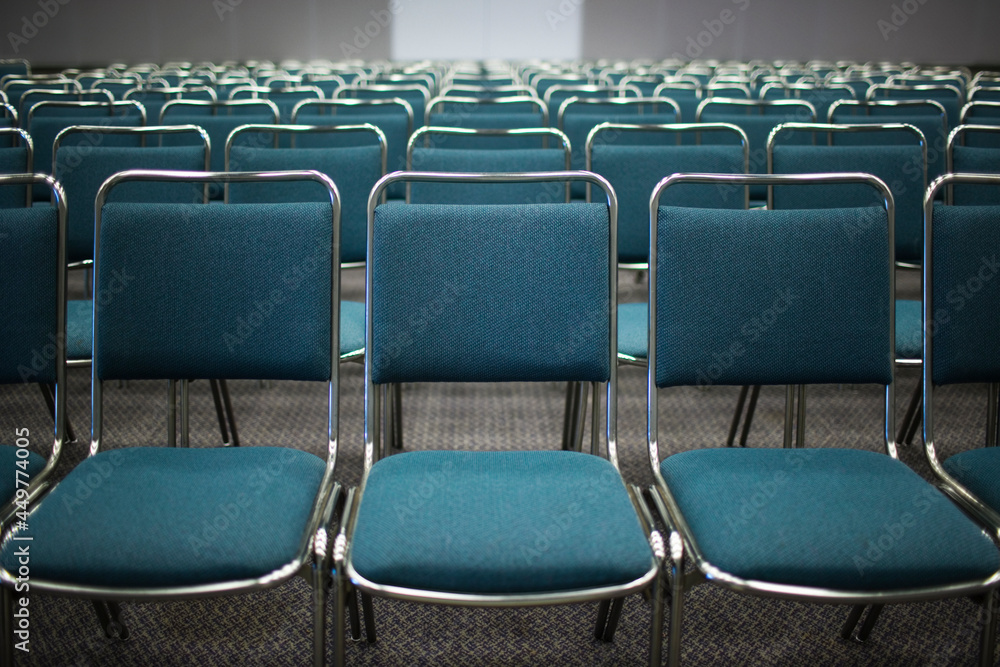Rows of empty blue chairs in conference room Rows of empty blue chairs in conference room