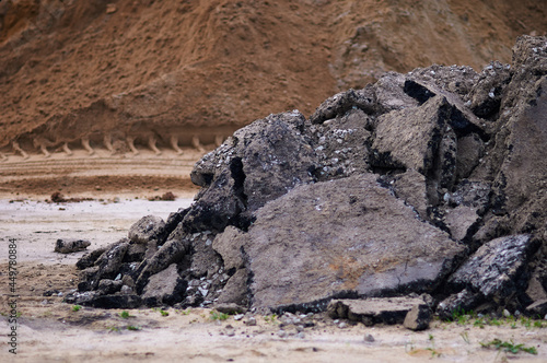 Wallpaper Mural Pieces of asphalt in a heap during road works. Selective focus. A pile of sand is blurred in the background. Torontodigital.ca