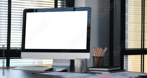 Mock up computer with empty display on office desk.