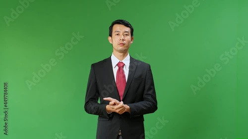 Young Asian Businessman In Suit Jacket Standing And Presenting Something On Green Screen Background, Chroma Key
 photo