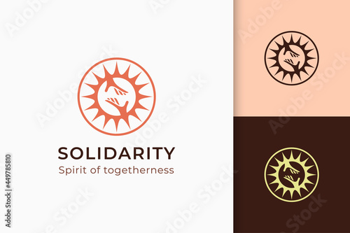 Charity or donation logo in hand and sun represent peace or solidarity