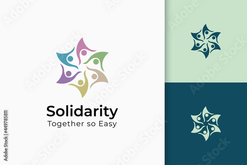 Charity or together logo in hand and sun represent peace or solidarity