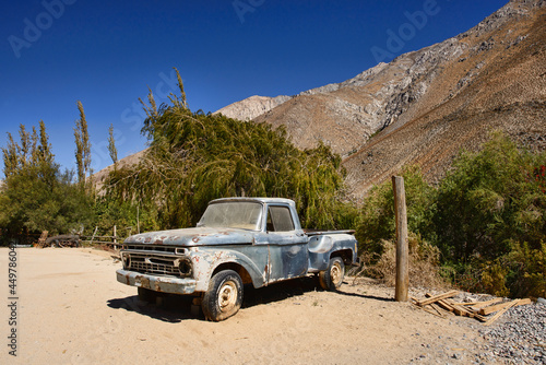 An old car parked in Cochiguaz village is noted for New Age and also UFO sightings. Note the falling object in the photo above the tree! Elqui Valley, Chile photo