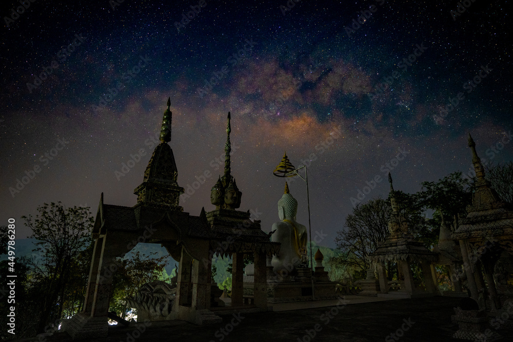 Buddha statue against starry sky with Milky Way. Space background. Night landscape with Buddha statue and colorful bright milky way. Amazing galaxy. Beautiful scene with universe. Buddha statue against starry sky with Milky Way. Space background. Night landscape with Buddha statue and colorful bright milky way. Amazing galaxy. Beautiful scene with universe.
