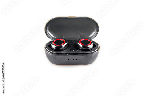 Close-up of wireless earphones in a recharging box on a white background.