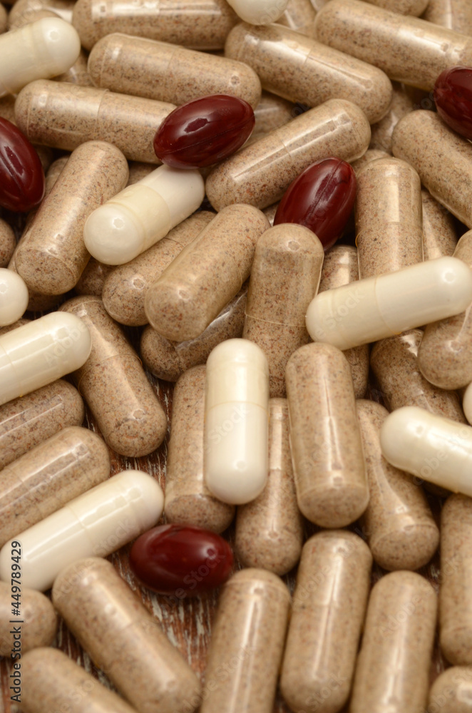 pills on a wooden background/milk thistle/lycopene/l-arginine pills on a wooden background/milk thistle/lycopene/l-arginine