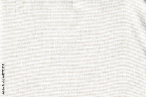 The texture of natural soft cotton fabric in a barely noticeable stripe. Simple abstract background. Table napkin.