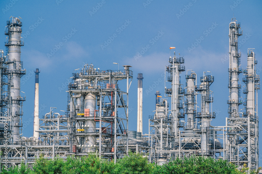 Fototapeta premium Industrial zone,The equipment of oil refining,Close-up of industrial pipelines of an oil-refinery plant,Detail of oil pipeline with valves in large oil refinery.